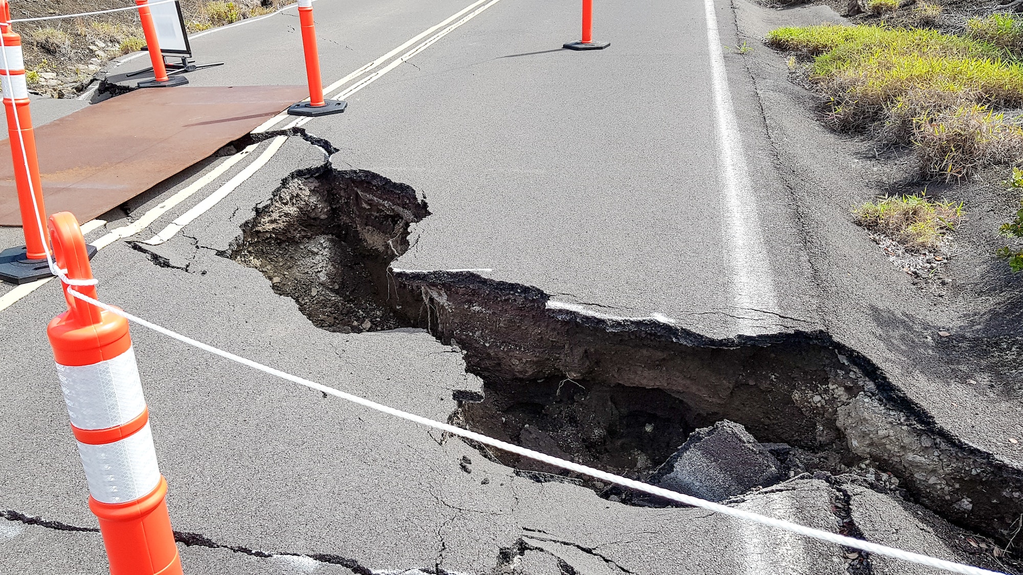 Volcano road cracks and danger cones